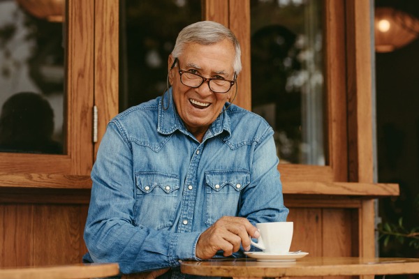Smiling senior man relaxing at cafe
