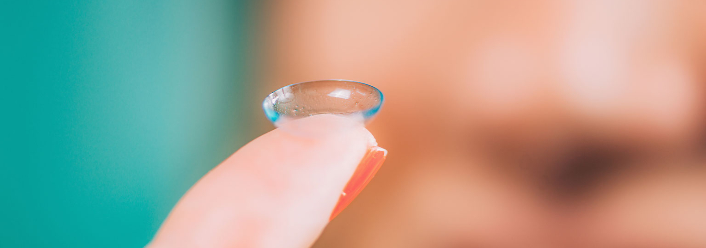 Girl holding contact lens